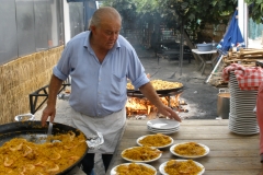 Ayo serving paella at his beach restaurant
